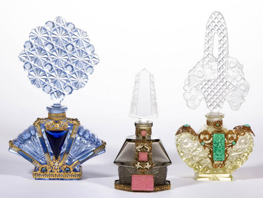 ASSORTED JEWELLED CZECH GLASS PERFUME BOTTLES, LOT OF: ASSORTED JEWELLED CZECH GLASS PERFUME BOTTLES, LOT OF THREE, pale yellow, blue, and grey, comprising a fan-form with a central triangular blue jewel and a brass cage, a heart-form with a few opaque gr