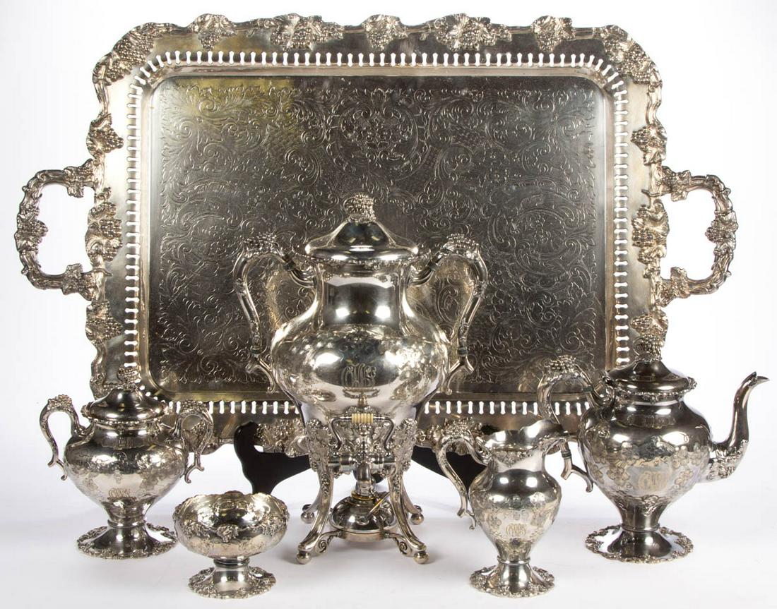 E.G. WEBSTER & SON CHASED SILVER-PLATED FIVE-PIECE TEA: E.G. WEBSTER & SON CHASED SILVER-PLATED FIVE-PIECE TEA SERVICE, comprising a teapot, a tea urn including a burner, a covered sugar bowl, a creamer, and a waste bowl, each having a chased grapevine dec