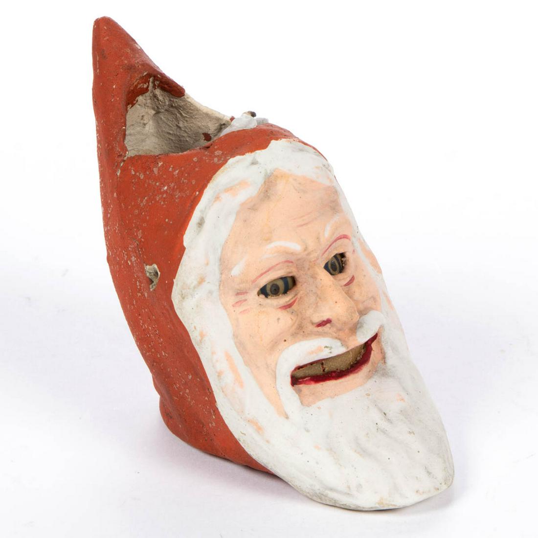 RARE GERMAN COMPOSITION / PAPIER MACHE FIGURAL: RARE GERMAN COMPOSITION / PAPIER MACHE FIGURAL BELSNICKEL / SANTA CLAUS CANDLE LANTERN ORNAMENT, retaining original paper eyes and teeth, and paint-decorated surface with mica highlights. Late 19th/ea