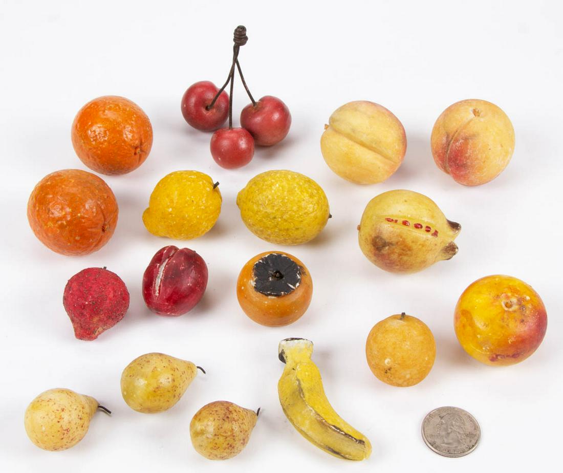 ANTIQUE MINIATURE CARVED STONE FRUIT, LOT OF 17: ANTIQUE MINIATURE CARVED STONE FRUIT, LOT OF 17, each with painted and stained decoration, various examples include apples, a banana, cherries with stem, lemons, peaches, pears, and oranges. Late 19th
