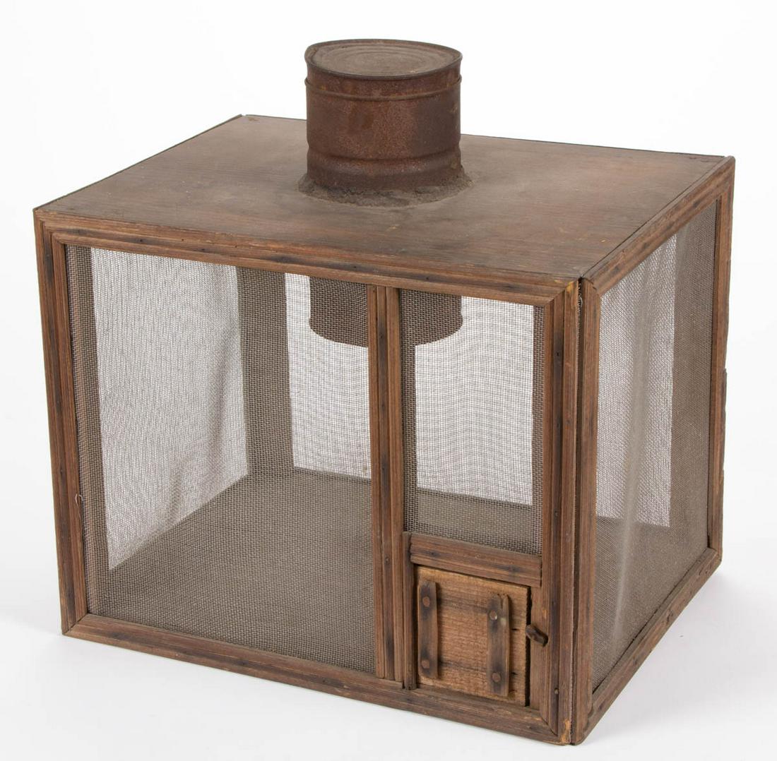 AMERICAN WOOD AND SHEET-IRON FOLK ART SQUIRREL CAGE: AMERICAN WOOD AND SHEET-IRON FOLK ART SQUIRREL CAGE, old surface and warm color. Late 19th/ first quarter 20th century. 16 3/4" HOA, 16" W, 12" D. Very good overall condition, with areas of expected u