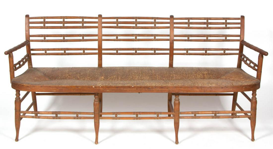 AMERICAN WINDSOR SETTEE / BENCH: AMERICAN WINDSOR SETTEE / BENCH, featuring likely original rush seat with an old brown painted surface. Old surface with warm color. Second half 19th century. 34" H, 72" W, 21" D. Very good overall co