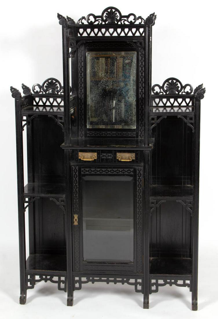AESTHETIC MOVEMENT EBONIZED ETAGERE WITH BEVELED GLASS: AESTHETIC MOVEMENT EBONIZED ETAGERE WITH BEVELED GLASS, featuring mirror and hinged door flanked by six shelves. Fourth quarter 19th century. 66 1/4" HOA, 42" W, 11 3/4" D. Very good overall condition
