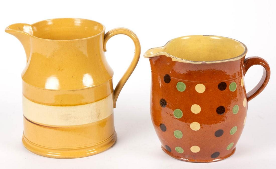 FRENCH / AMERICAN EARTHENWARE JUGS / PITCHERS, LOT OF: FRENCH / AMERICAN EARTHENWARE JUGS / PITCHERS, LOT OF TWO, comprising a yellowware example featuring broad white band with thin brown line below and a terra cotta Jaspe example with yellow-slipped int