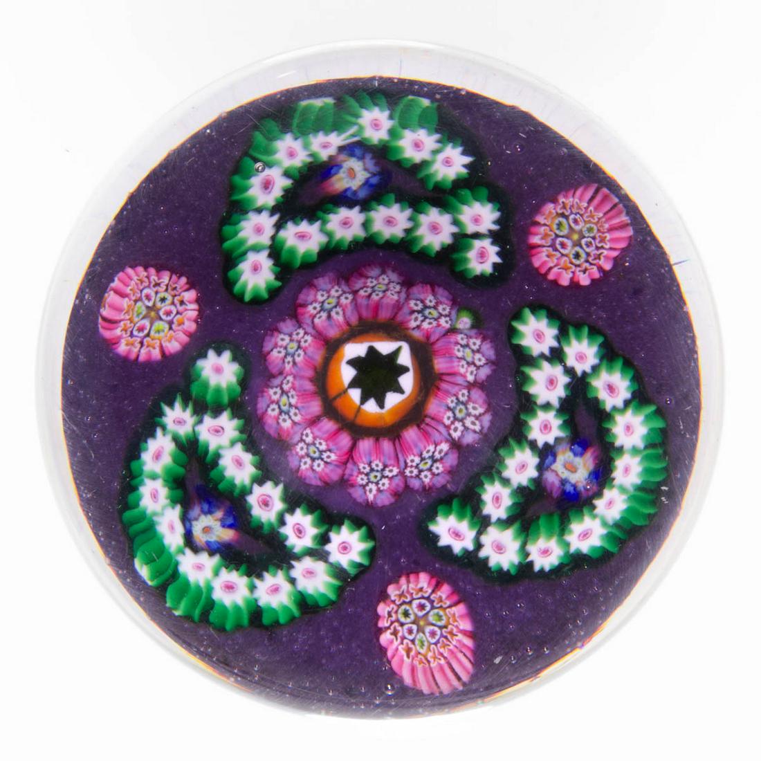 EARLY PAUL YSART (SCOTTISH, 1904-1979) TREFOIL: EARLY PAUL YSART (SCOTTISH, 1904-1979) TREFOIL MILLEFIORI ART GLASS PAPERWEIGHT, encasement having a purple tint, large central orange and white eight-point star cane encircled by a single ring of pin