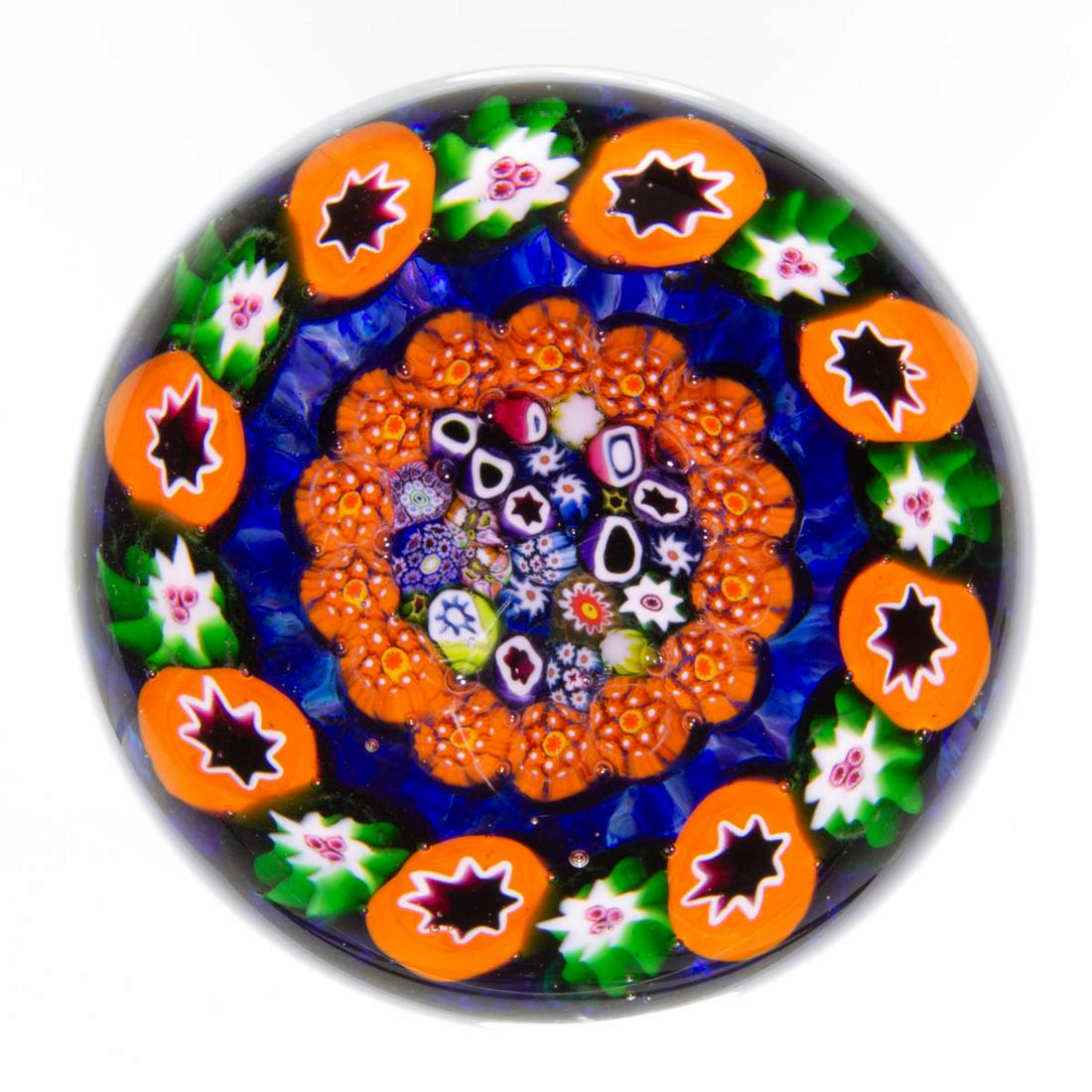 EARLY PAUL YSART (SCOTTISH, 1904-1979) ATTRIBUTED: EARLY PAUL YSART (SCOTTISH, 1904-1979) ATTRIBUTED CLOSE-PACK MEDALLION MILLEFIORI ART GLASS PAPERWEIGHT, encasement having a purple tint, encircled close-pack millefiori medallion featuring a variety 