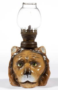 GERMAN ERNST BOHNE SOHNE PORCELAIN LION-HEAD FIGURAL: GERMAN ERNST BOHNE SOHNE PORCELAIN LION-HEAD FIGURAL MINIATURE LAMP, brown tones with dark highlights, wavy fur, facial features including green eyes and whiskers, underside of base lightly stamped wi