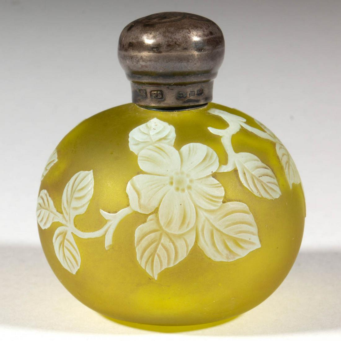 ENGLISH CAMEO ART GLASS PERFUME BOTTLE: ENGLISH CAMEO ART GLASS PERFUME BOTTLE, opaque white to Citron, globular with floral decoration, silver-plated collar and lid, silver-plating marked "CS/FS", lacking interior stopper. Stevens & Willia