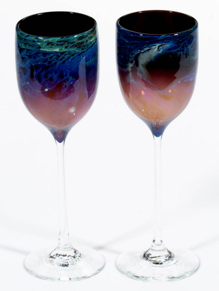 JOSH SIMPSON NEW MEXICO STUDIO ART GLASS PAIR OF: JOSH SIMPSON NEW MEXICO STUDIO ART GLASS PAIR OF GOBLETS / WINE GLASSES, amethyst with mottled blue decoration, each having an ovoid bowl and long thin stems, and a circular foot, each signed "Simpson