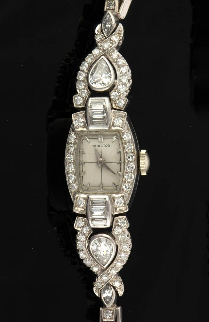 VINTAGE PLATINUM AND 2.61 CTW DIAMOND LADY'S WRIST: VINTAGE PLATINUM AND 2.61 CTW DIAMOND LADY'S WRIST WATCH, platinum case and bracelet having a Hamilton 757 22-jewel movement with winding mechanism, a fold-over clasp with safety chain, and 85 diamond