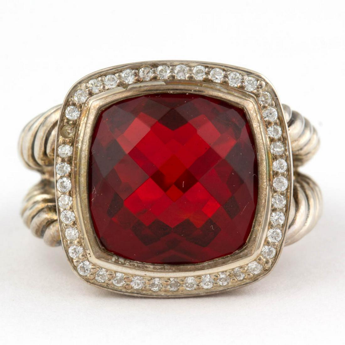 DAVID YURMAN STERLING SILVER AND GARNET SOLITAIRE RING: DAVID YURMAN STERLING SILVER AND GARNET SOLITAIRE RING, having a 14 mm square checkerboard-cut red garnet surrounded by a hallow of colorless melee stones, on a split-shank cable band. Marked "(c) D. 