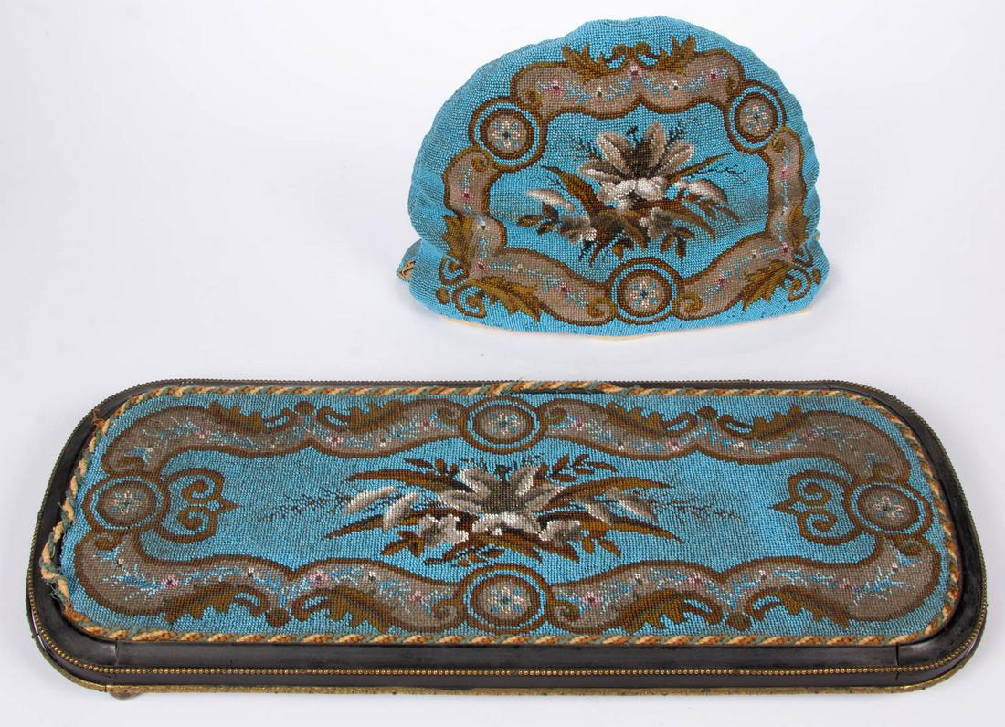 ENGLISH VICTORIAN BEADWORK TEA COZY AND MATCHING STAND: ENGLISH VICTORIAN BEADWORK TEA COZY AND MATCHING STAND / TRAY, each with scrollwork surrounding a bouquet of lilies, one a turquoise ground, cozy with original liner, ebonywood stand/tray with gilt-br