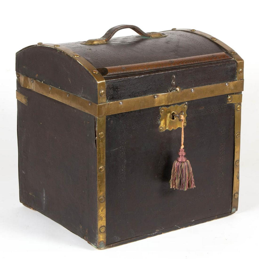 VICTORIAN BRASS-BOUND, LEATHER-COVERED MILLINERY TRUNK: VICTORIAN BRASS-BOUND, LEATHER-COVERED MILLINERY TRUNK, tooled decoration, domed top with mounted oak slats and original handle, original brass-face lock with working key, original paper-lined interio