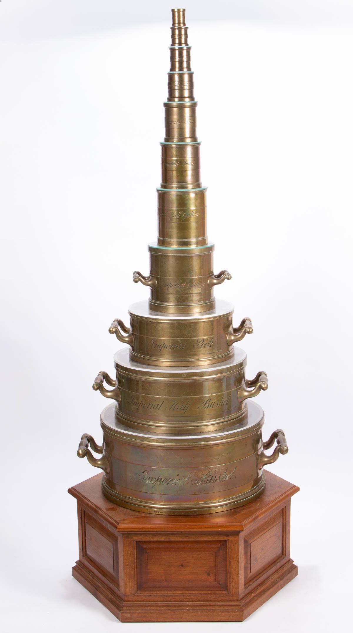 RARE GRADUATED SET OF 11 BRITISH IMPERIAL STANDARD: RARE GRADUATED SET OF 11 BRITISH IMPERIAL STANDARD BRONZE / BELL BRASS MEASURES, "BUSHEL" to "QUARTER GILL", each of cylindrical drum form, marked "EAST SUSSEX" and bearing numerous proof marks, inclu