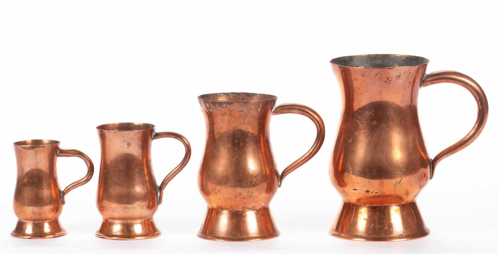SET OF FOUR BRITISH COPPER MEASURES: SET OF FOUR BRITISH COPPER MEASURES, "HALF PINT" to "HALF GILL", each of tankard form, two bearing numerous proof marks, including those denoting various reigns. 19th century. Half Pint 4 3/4" H. Very