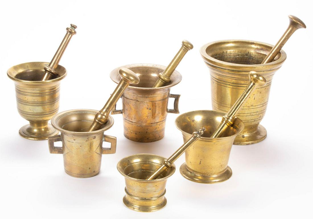 BRITISH / CONTINENTAL BRASS MORTARS AND PESTLES, LOT OF: BRITISH / CONTINENTAL BRASS MORTARS AND PESTLES, LOT OF SIX, including a footed example with decorative bands to body, no markings located. Each 18th century or earlier. Largest example 8" H rim of mo