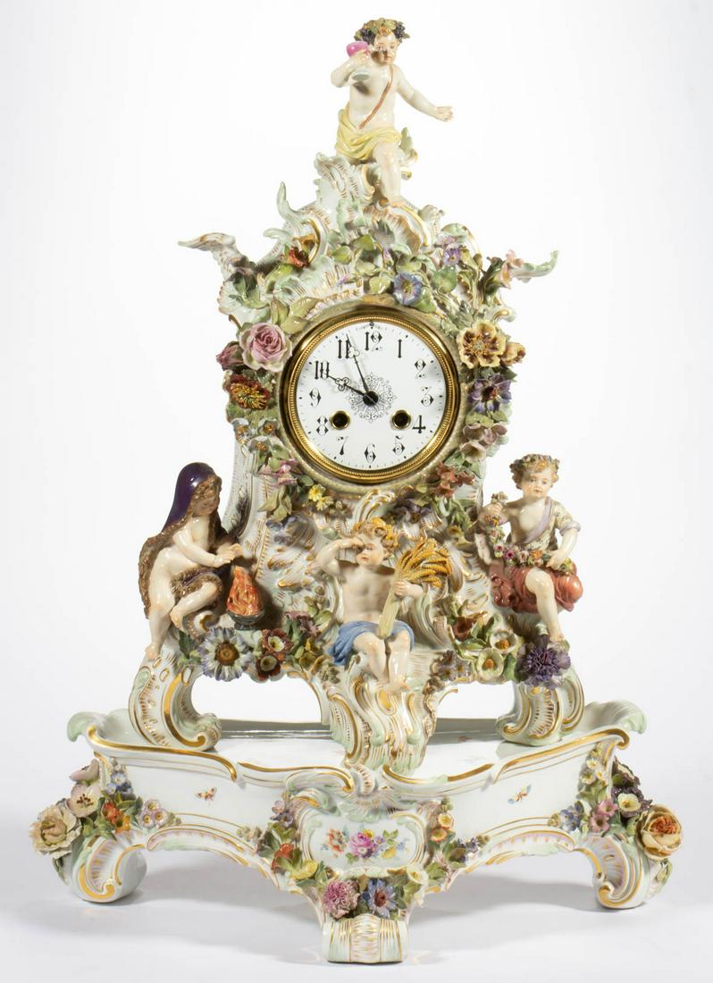 GERMAN MEISSEN "FOUR SEASONS" PORCELAIN MANTLE CLOCK: GERMAN MEISSEN "FOUR SEASONS" PORCELAIN MANTLE CLOCK AND STAND, featuring four cherubs/putti representing Spring, Summer, Autumn, and Winter, with beautiful applied flowers and molded acanthus leaf sc