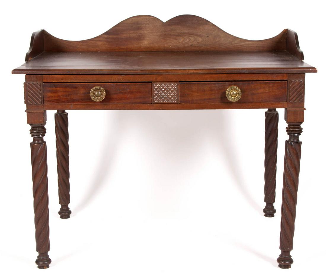 WEST INDIAN MAHOGANY WRITING TABLE: WEST INDIAN MAHOGANY WRITING TABLE, rectangular top with applied gallery, above two deep drawers, raised on rope-twist legs terminating in disc and spike foot. Old surface with warm color. 19th centur