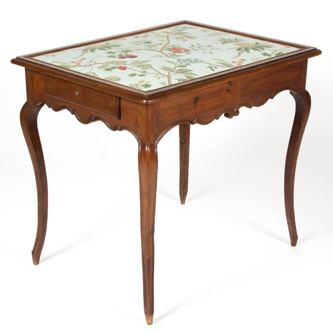 FRENCH COUNTRY FRUITWOOD SEWING TABLE: FRENCH COUNTRY FRUITWOOD SEWING TABLE, featuring later upholstery, two drawers, the whole raised on cabriole legs. Old surface with warm color. Late 19th/early 20th century. 29 1/2" H, 32" W, 25" D.Ve