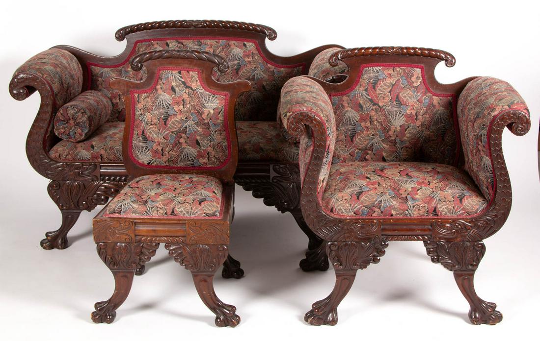 EMPIRE REVIVAL CARVED MAHOGANY PARLOR SUITE, THREE: EMPIRE REVIVAL CARVED MAHOGANY PARLOR SUITE, THREE PIECES, comprising settee and two chairs. Likely original surface with warm color. First quarter 20th century. Settee 35 1/4" H, 19" H seat, 55 1/4" 
