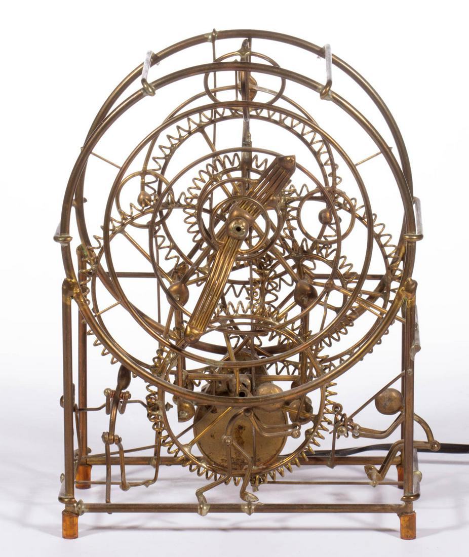 GORDON BRADT KINETICO "THREE MAN" SHELF CLOCK: GORDON BRADT KINETICO "THREE MAN" SHELF CLOCK, brass frame with visible gears and three male figures, retaining printed label applied to reverse. Circa 1990. 9 3/4" HOA, 7" WOA, 4" DOA. Very good over