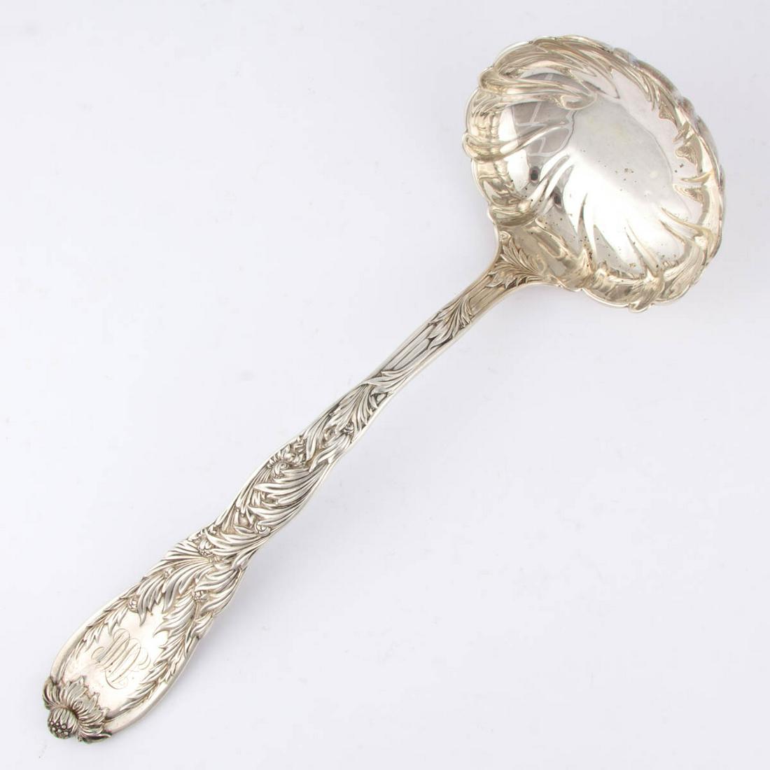 TIFFANY & CO. "CHRYSANTHEMUM" STERLING SILVER SOUP: TIFFANY & CO. "CHRYSANTHEMUM" STERLING SILVER SOUP LADLE, pattern designed by Charles Grosjean in 1880, comprising a swirl-fluted round bowl on a long curved handle featuring relief chrysanthemum flow
