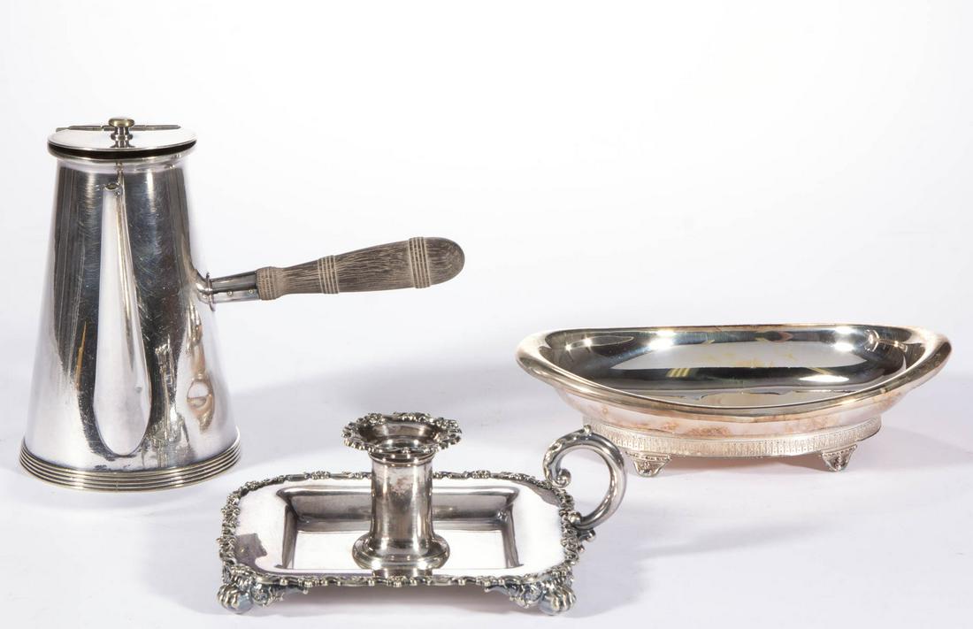 TIFFANY & CO. SILVER-PLATED ARTICLES, LOT OF THREE: TIFFANY & CO. SILVER-PLATED ARTICLES, LOT OF THREE, comprising a chocolate pot with wooden handle to side, a small oval dish raised on four short feet, and a chamberstick having flower and scroll patt