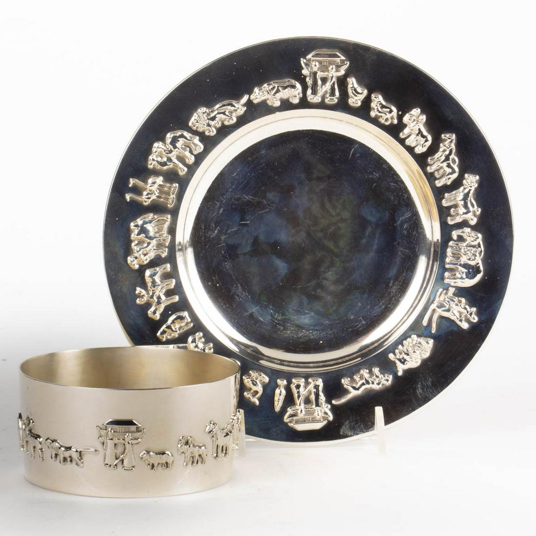 GORHAM "NOAH'S ARK" STERLING SILVER TWO-PIECE CHILD'S: GORHAM "NOAH'S ARK" STERLING SILVER TWO-PIECE CHILD'S SET, comprising a bowl and a plate, each featuring relief figures of animals including elephants, horses, lions, and camels walking towards the ar