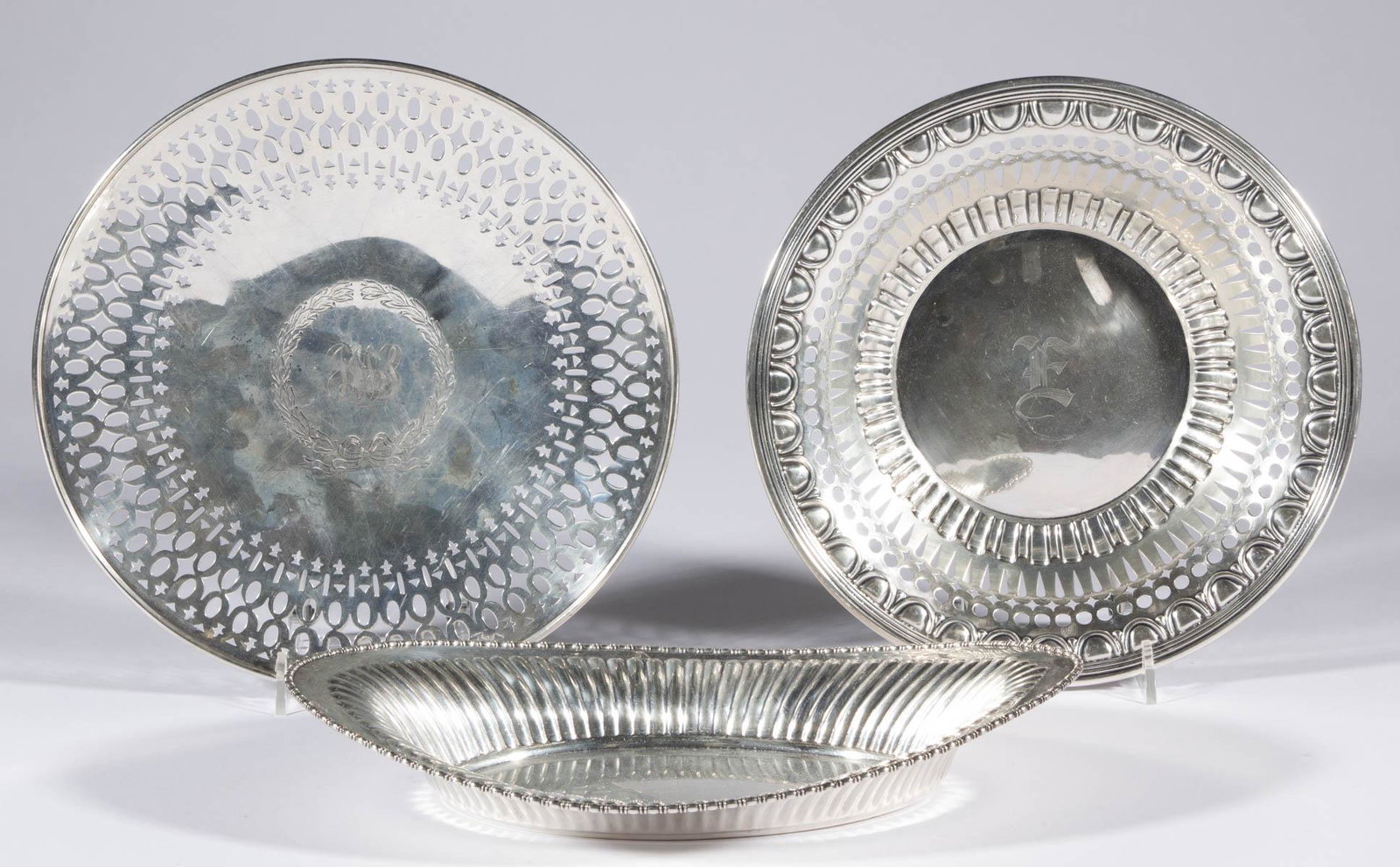 GORHAM AND OTHER AMERICAN STERLING SILVER SERVING: GORHAM AND OTHER AMERICAN STERLING SILVER SERVING DISHES, LOT OF THREE, comprising a reticulated cake plate by Gorham Manufacturing Co. with 1910 date mark, a reticulated bowl by Whiting Mfg. Co. with