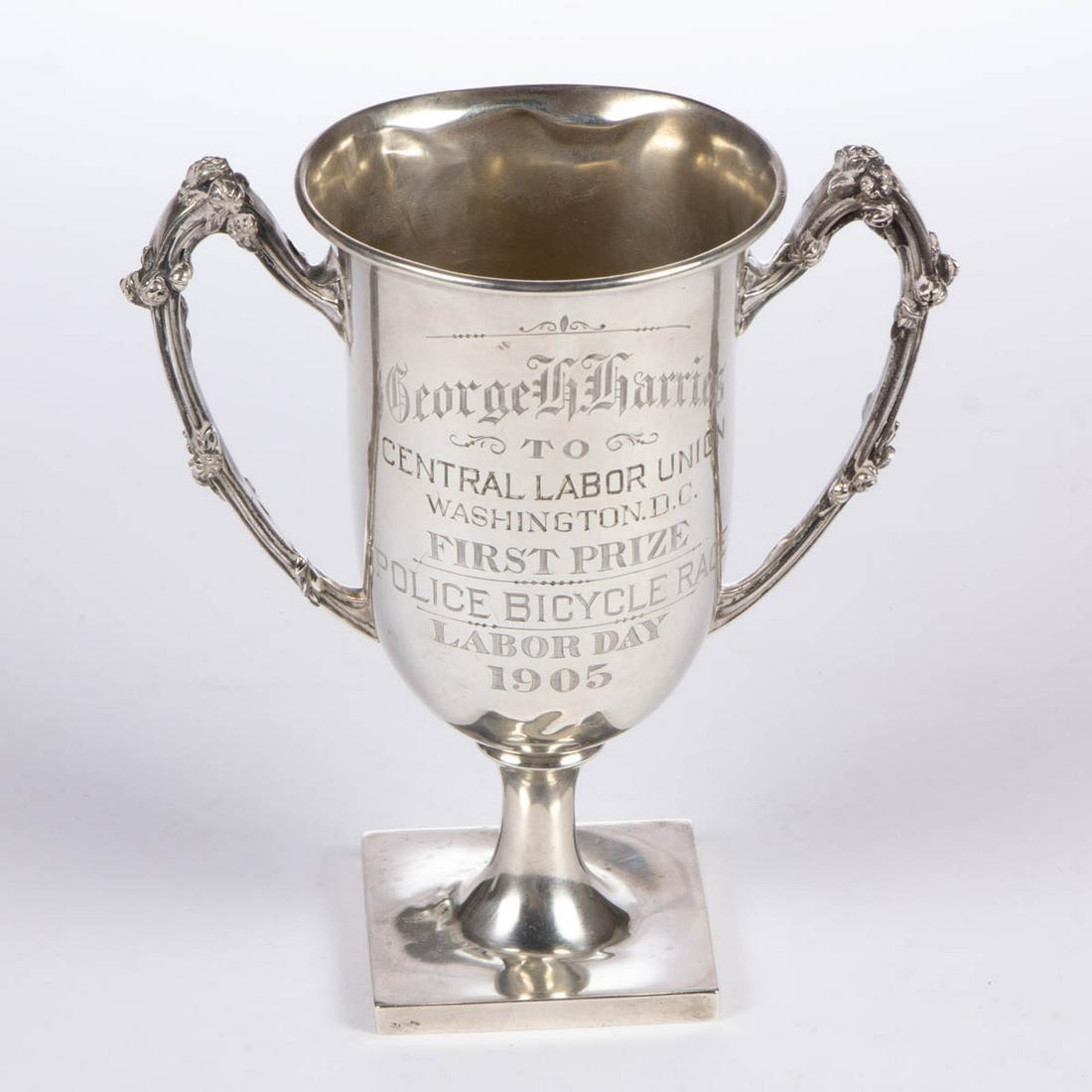 WASHINGTON, D.C. POLICE BICYCLE RACE STERLING SILVER: WASHINGTON, D.C. POLICE BICYCLE RACE STERLING SILVER TROPHY, semi-ovoid well with flared rim, having two loop handles with relief flower buds, raised on a stemmed base with square foot, featuring "Geo