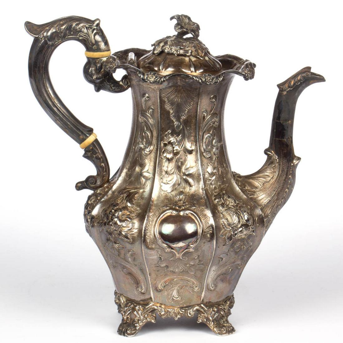 SCOTTISH REPOUSSE AND CHASED STERLING SILVER COFFEE POT: SCOTTISH REPOUSSE AND CHASED STERLING SILVER COFFEE POT, vase-form well with ornate repousse and chased designs of leaves and flowers, topped by a hinged lid with blossom finial, having scrolled handl