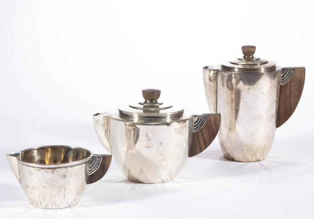MERIDEN BRITANNIA ART DECO STERLING SILVER THREE-PIECE: MERIDEN BRITANNIA ART DECO STERLING SILVER THREE-PIECE COFFEE AND TEA SERVICE, comprising a coffee pot, a teapot, and a creamer, each having a tapered well with fluting near the base, a curved exotic