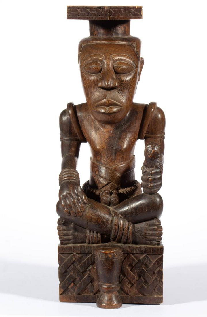 AFRICAN CARVED WOODEN FIGURAL STATUE: AFRICAN CARVED WOODEN FIGURAL STATUE, seated figure with a drum. Old surface with warm color. 20th century. 19 1/2" HOA. Very good overall condition, scattered minor to moderate old cracks. Provenance