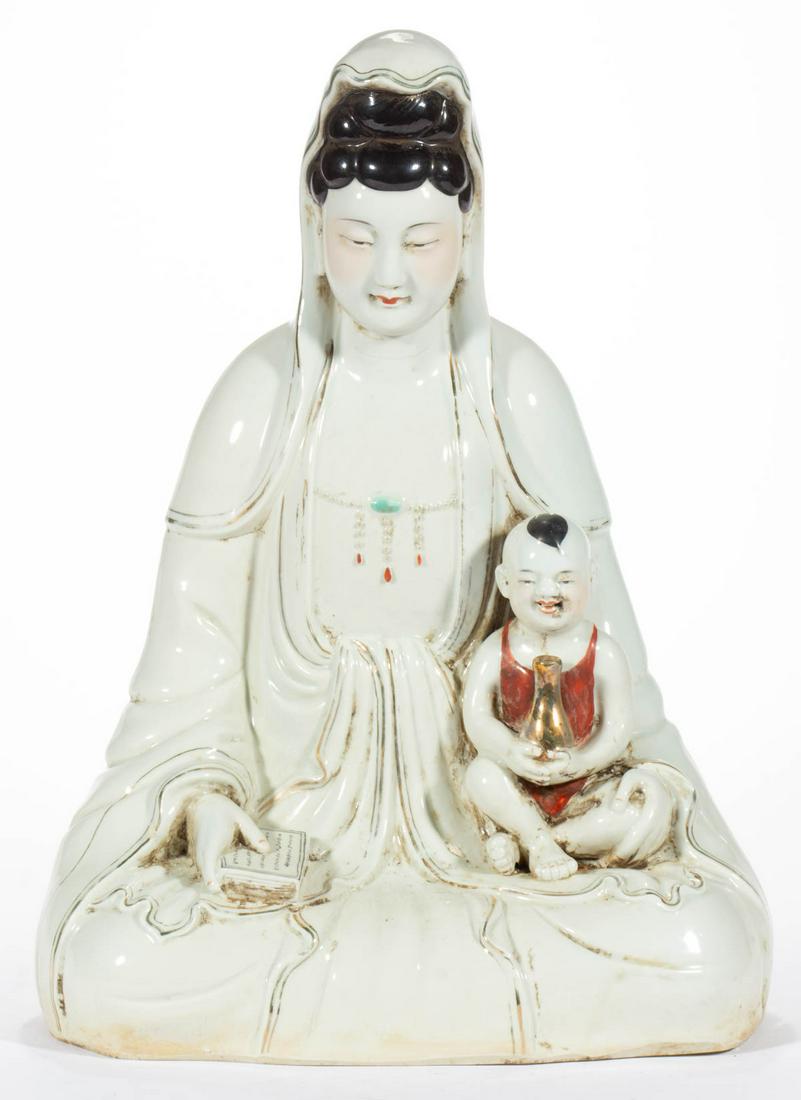 CHINESE EXPORT PORCELAIN KWAN-YIN GUANYIN FIGURE: CHINESE EXPORT PORCELAIN KWAN-YIN GUANYIN FIGURE, sitting with serene facial expression, holding a book in right hand and a child holding a gilt bottle on left, having minimal polychrome enamel and gi
