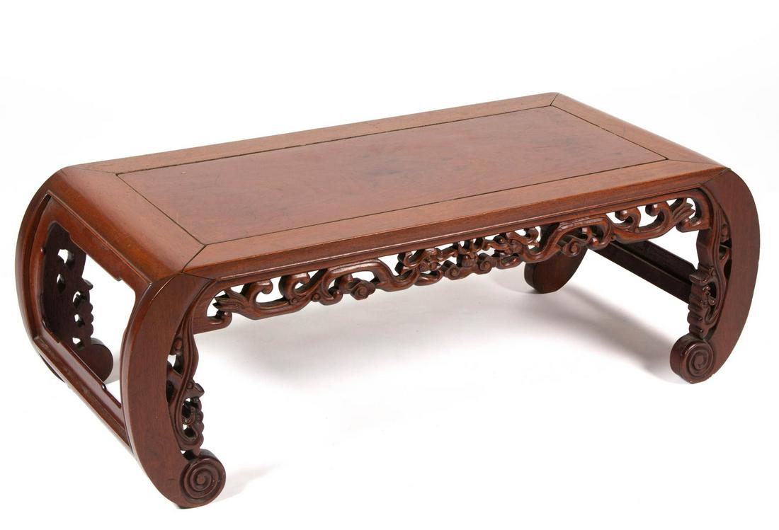 CHINESE TEAKWOOD COFFEE TABLE: CHINESE TEAKWOOD COFFEE TABLE, with scrolled feet. Old surface with warm color. First half 20th century. 13" H, 35" W, 16 1/4" D. Very good overall condition, scattered minor areas of discoloration an