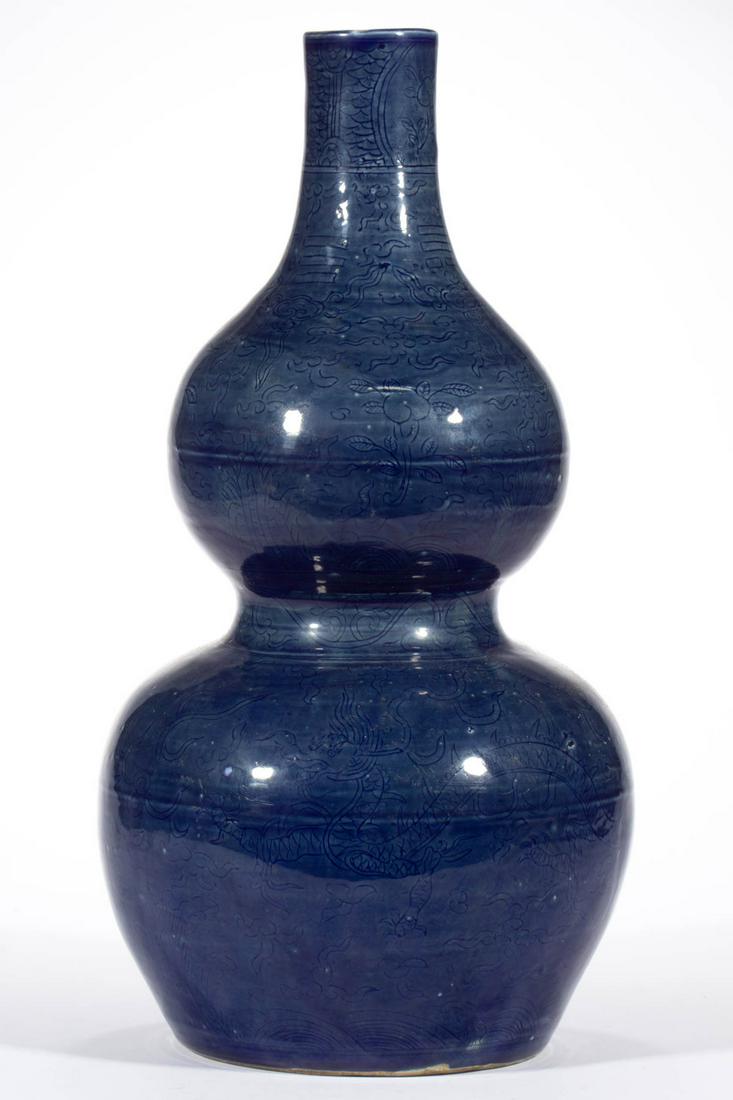 CHINESE EXPORT PORCELAIN DOUBLE GOURD VASE: CHINESE EXPORT PORCELAIN DOUBLE GOURD VASE, cobalt blue glaze with lightly incised decorations featuring dragons to lower half and floral designs to top. Having blue six-character Zhengde mark to unde