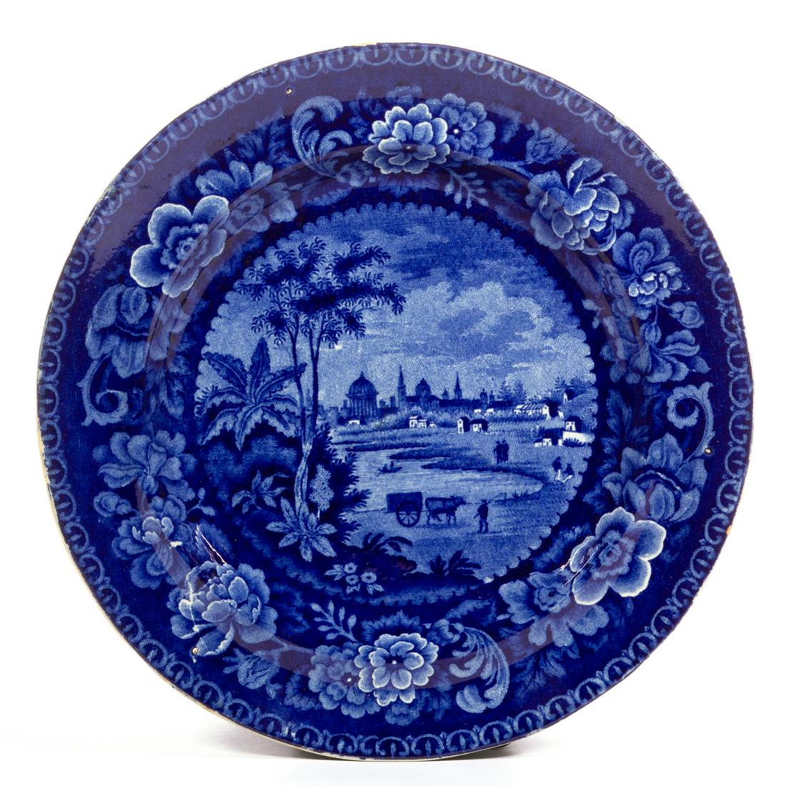 STAFFORDSHIRE ARGENTINIAN VIEW TRANSFER-PRINTED CERAMIC: STAFFORDSHIRE ARGENTINIAN VIEW TRANSFER-PRINTED CERAMIC PLATE, featuring "BUENOS AYRES", as printed to underside, depicting a figure with ox-cart in foreground and cityscape in background, from the Ci