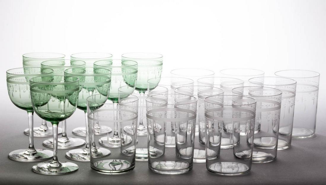 FREE-BLOWN AND ENGRAVED GLASS DRINKING ARTICLES, LOT OF: FREE-BLOWN AND ENGRAVED GLASS DRINKING ARTICLES, LOT OF 20, comprising 12 matching colorless water tumblers with loop and dart decoration, and eight green wines with matching engraved decoration havin
