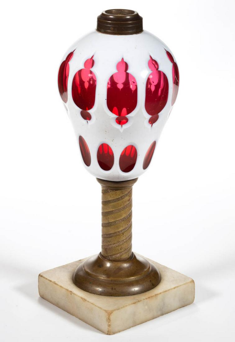 CUT OVERLAY MOORISH WINDOWS KEROSENE STAND LAMP: CUT OVERLAY MOORISH WINDOWS KEROSENE STAND LAMP, white to ruby elongated pyriform font, brass stem with swirling bands of alternating ribbing and plain pattern, single-step marble base, No. 1 fine-lin