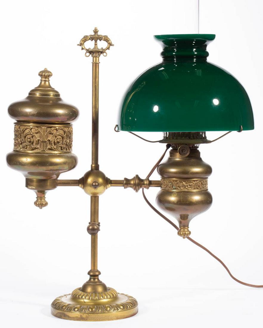 EDWARD MILLER BRASS STUDENT LAMP: EDWARD MILLER BRASS STUDENT LAMP, vertical shaft with adjustable height and circular-form weighted foot with beaded pattern, banded font with cast-brass ornamentation medial band, matching reservoir a