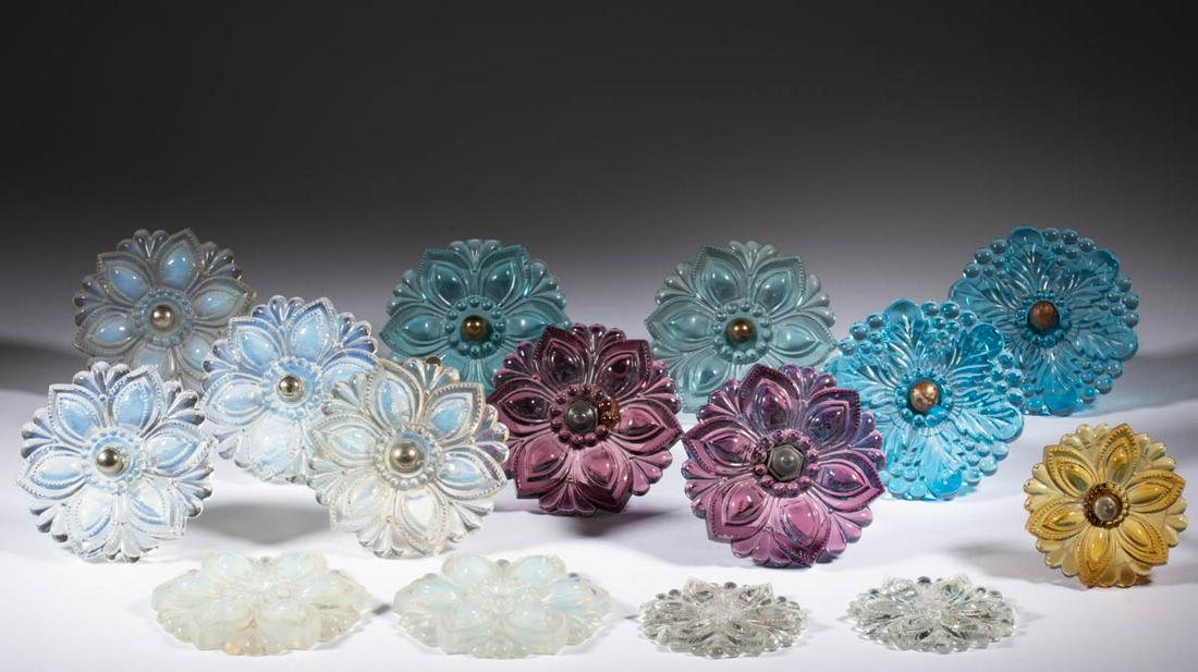 ASSORTED PRESSED CZECH REPRODUCTION GLASS CURTAIN PINS: ASSORTED PRESSED CZECH REPRODUCTION GLASS CURTAIN PINS / TIE BACKS, LOT OF 15, fiery opalescent, amber, amethyst, and blue, comprising 13 Rosette examples and 2 foliate examples, 11 having a metal sha