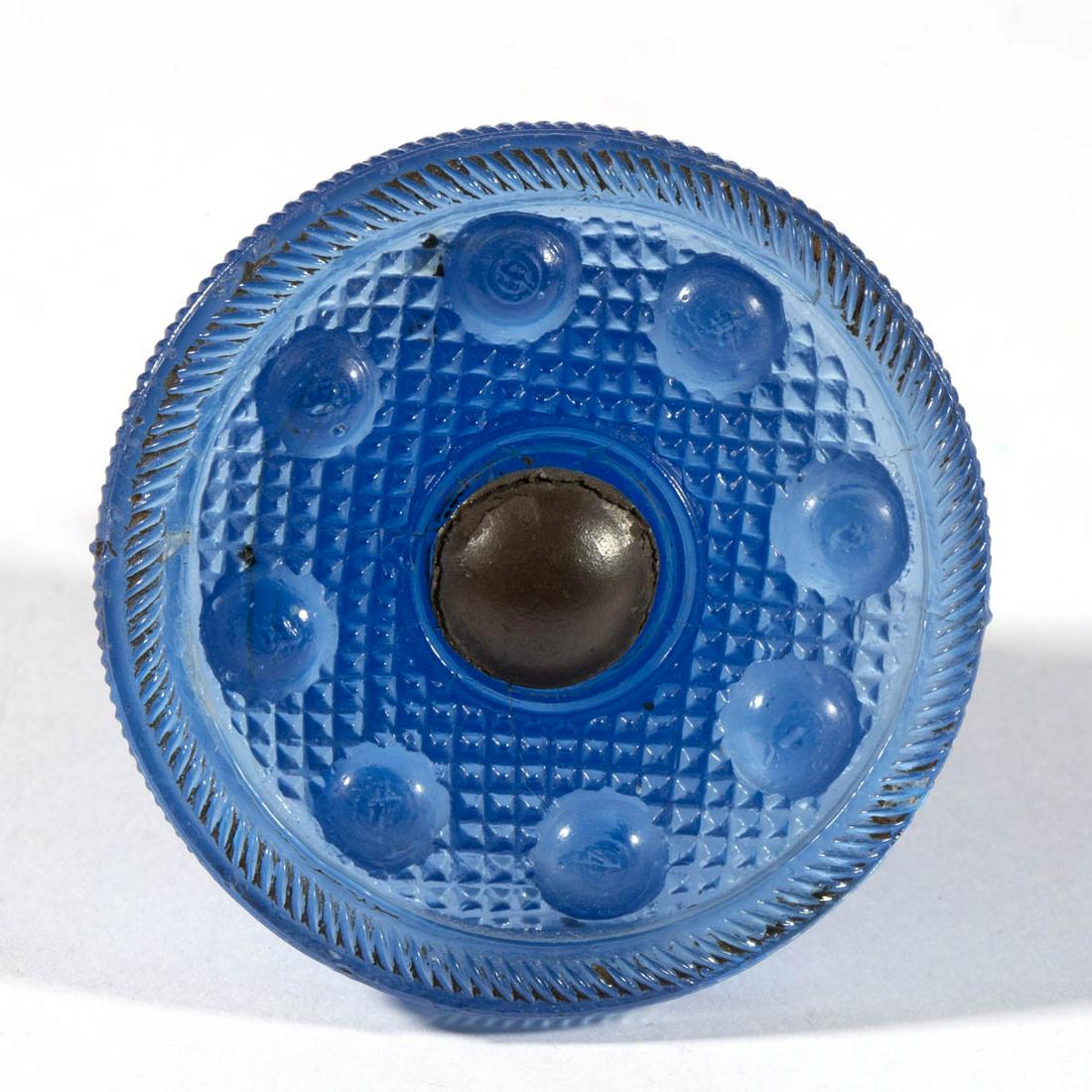 PRESSED BAKEWELL ATTRIBUTED GLASS FURNITURE KNOB: PRESSED BAKEWELL ATTRIBUTED GLASS FURNITURE KNOB, medium blue, eight small bull's eyes resting on a ground of small diamonds, period metal shank. Bakewell, Page & Bakewell. 1825-1835. 1 3/4" H, 2 1/8"