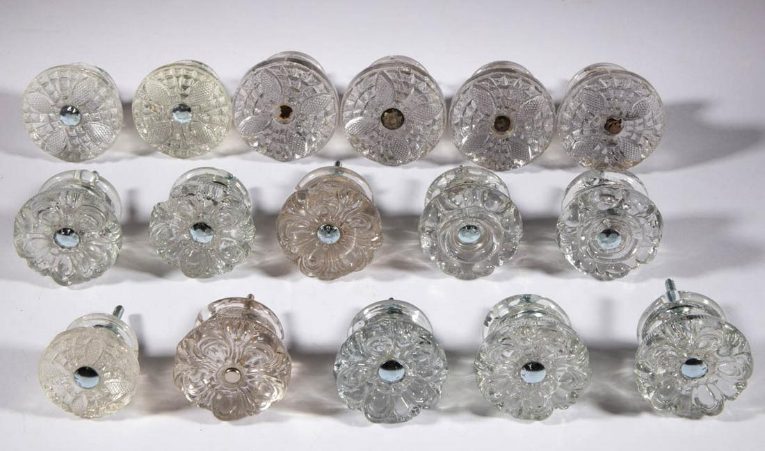 ASSORTED PRESSED GLASS FURNITURE KNOBS, LOT OF 16: ASSORTED PRESSED GLASS FURNITURE KNOBS, LOT OF 16, colorless, comprising seven mushroom-form with vesica and diamond pattern, seven five-petal examples, and two with a bead and swag pattern, four havi