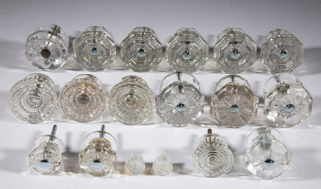 ASSORTED PRESSED GLASS FURNITURE KNOBS, LOT OF 18: ASSORTED PRESSED GLASS FURNITURE KNOBS, LOT OF 18, colorless and fiery opalescent, including five octagonal, five rayed, and two toy-sized opalescent examples, four having a period shank, 14 having a 