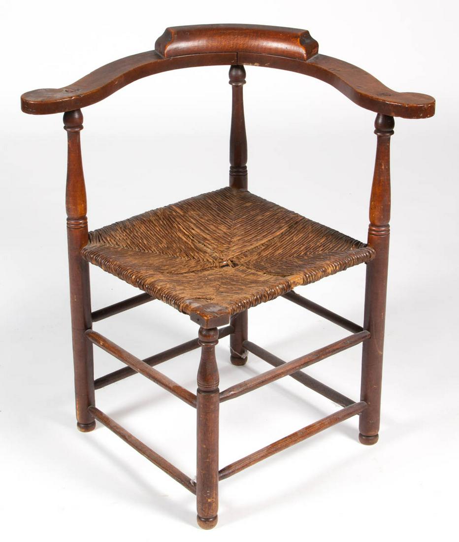 NEW ENGLAND CORNER / ROUNDABOUT CHAIR: NEW ENGLAND CORNER / ROUNDABOUT CHAIR, maple and oak, demilune crest rail with rounded terminals, supported on three turned posts, square seat with front corner block and old woven-rush, raised on tur