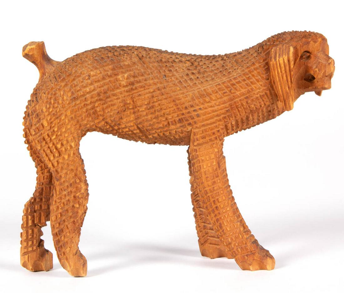 AARON MOUNTZ (PENNSYLVANIA, 1873-1949) ATTRIBUTED, FOLK: AARON MOUNTZ (PENNSYLVANIA, 1873-1949) ATTRIBUTED, FOLK ART CARVING OF A DOG, probably a poodle, with cross-hatched detail. Retains a fine original dry natural surface. First quarter 20th century. 4 1