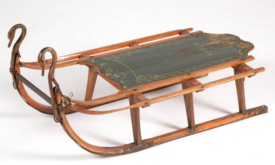 AMERICAN PAINT-DECORATED CHILD'S SLED: AMERICAN PAINT-DECORATED CHILD'S SLED, with iron runner blades, and swan- / duck-form hand holds, and stenciling featuring figure on horseback and "BUCKALOO". Worn original polychrome paint-decorated 