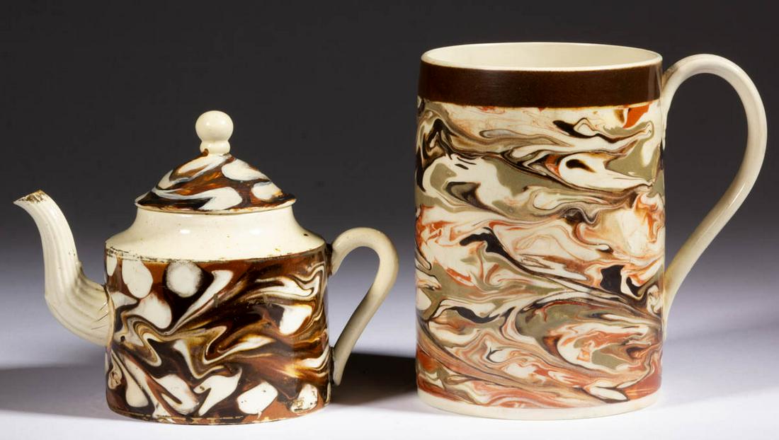 BRITISH CREAMWARE SLIP-MARBLED DIPPED WARE / MOCHA: BRITISH CREAMWARE SLIP-MARBLED DIPPED WARE / MOCHA CERAMIC DRINKING ARTICLES, LOT OF TWO, each featuring polychrome variegated decorations, comprising an approximately one-quart capacity cylindrical-f