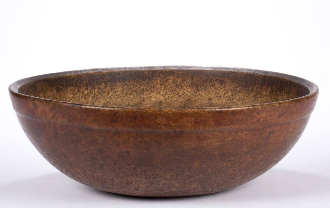 AMERICAN TURNED BURL TREENWARE BOWL: AMERICAN TURNED BURL TREENWARE BOWL, circular form, with molded rim, and slight grooved foot. Retains traces of an old red-painted surface. Late 18th/first quarter 19th century. 6 1/2" H, 18" x 18 1/4