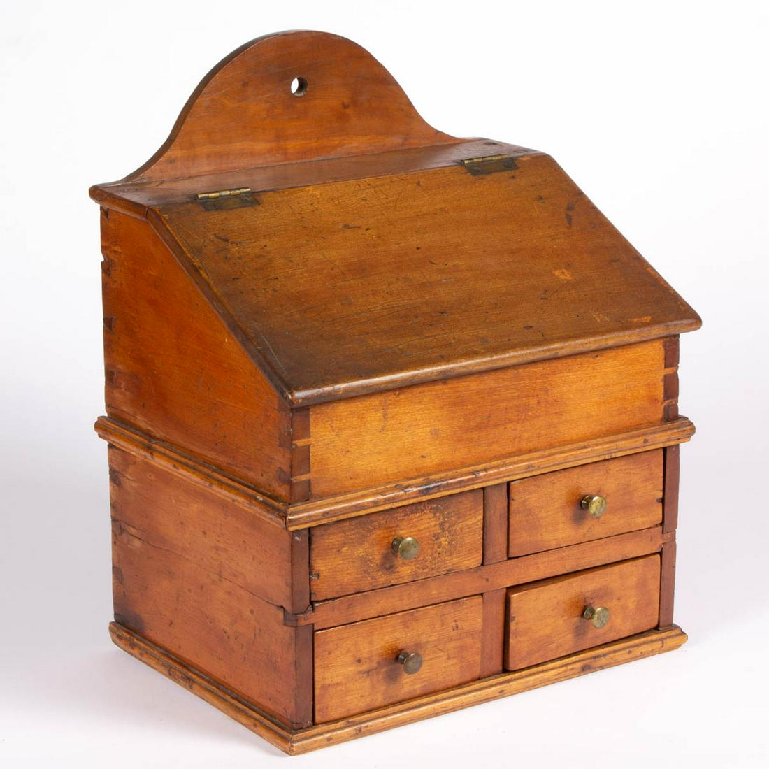 PENNSYLVANIA CHERRY HANGING SPICE / SALT BOX: PENNSYLVANIA CHERRY HANGING SPICE / SALT BOX, dovetailed construction, slanted lifting lid concealing an open interior with divider, above four drawers with likely original brass knobs, old ownership 